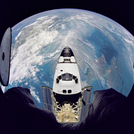 Fish-eye view of the Space Shuttle Atlantis as seen from the Russian Mir space station during the STS-71 mission.