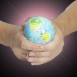 Man holding a glowing earth globe in his hands