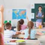 Cute little pupils during lesson in classroom