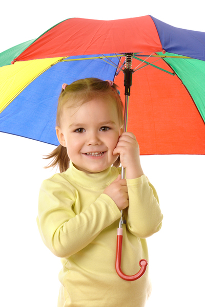 Cute cheerful child with colorful umbrella, isolated over white